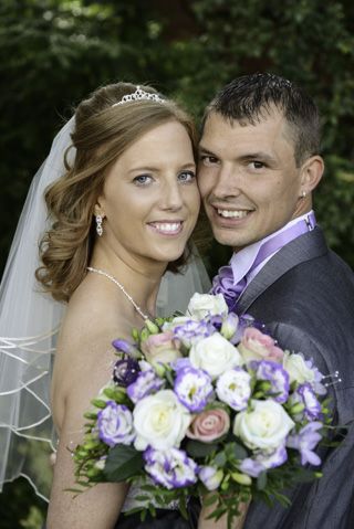 Bride and Groom with flowers looking back